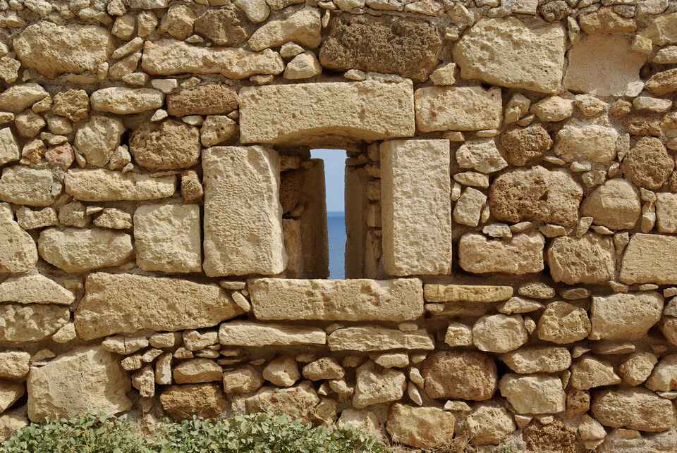 Stone wall with window in Crete, Greece